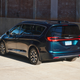 2023 Chrysler Pacifica Hybrid in teal, photographed next to a brick wall